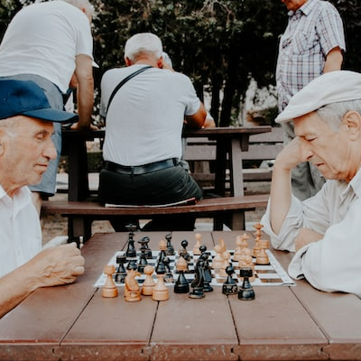 Seniors playing chess in a park